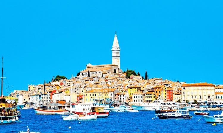 The charming city of Rovinj, featuring a distinctive tower that stands tall over the urban landscape.