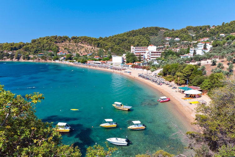 Aerial photo of Achladies, highlighting the beach and resort area with clear waters and lush landscapes.