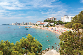 Beach resort town of Platja d’Aro on Spain’s Costa Brava with golden sand and Mediterranean sea
